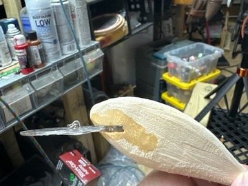 Wood carving with adhesive and a clamp.