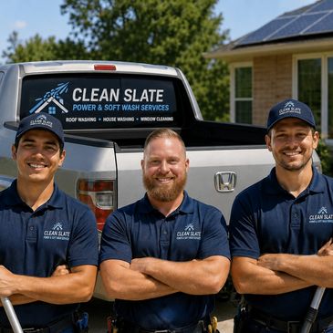 Three Clean Slate workers smiling in front of their service truck.