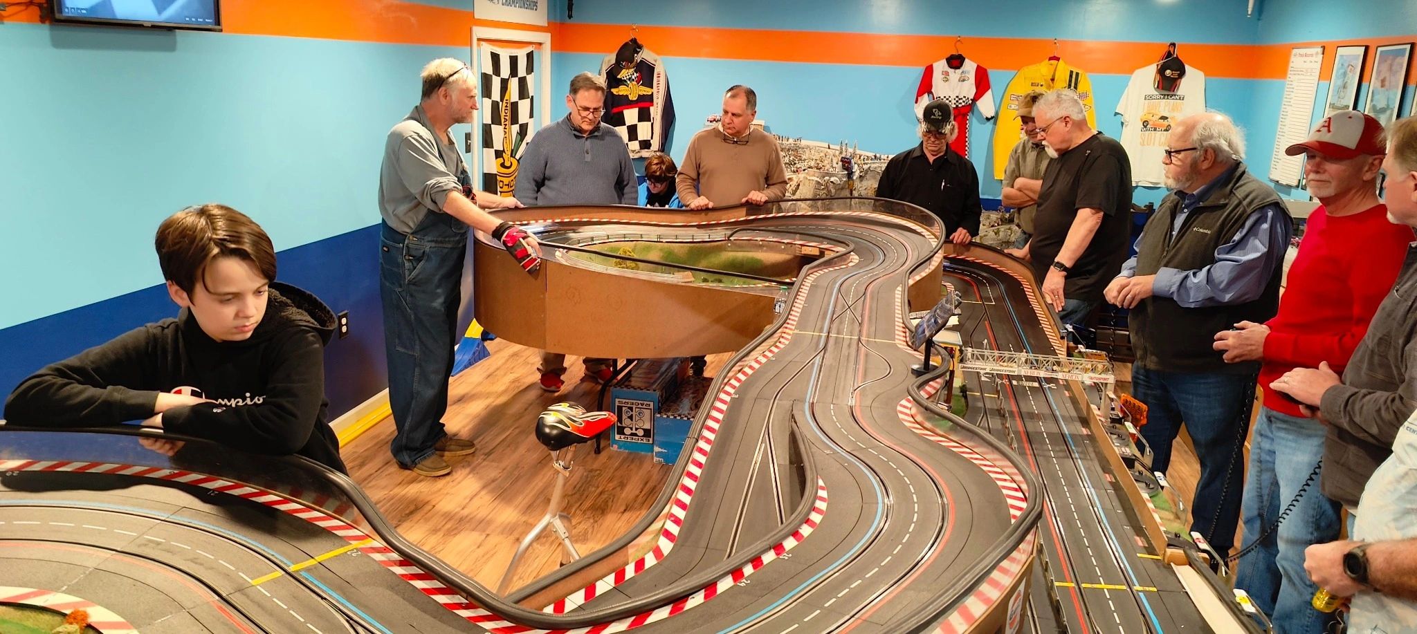 Slot car racers enjoying a multi-lane racing track at the Slotcar Clubhouse in Sherwood, Arkansas.