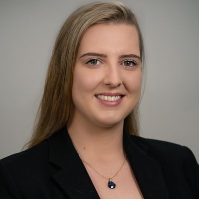 Professional headshot of a smiling woman with blonde hair.