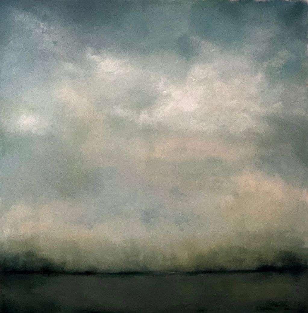 A moody, cloudy sky over a dark, calm body of water.