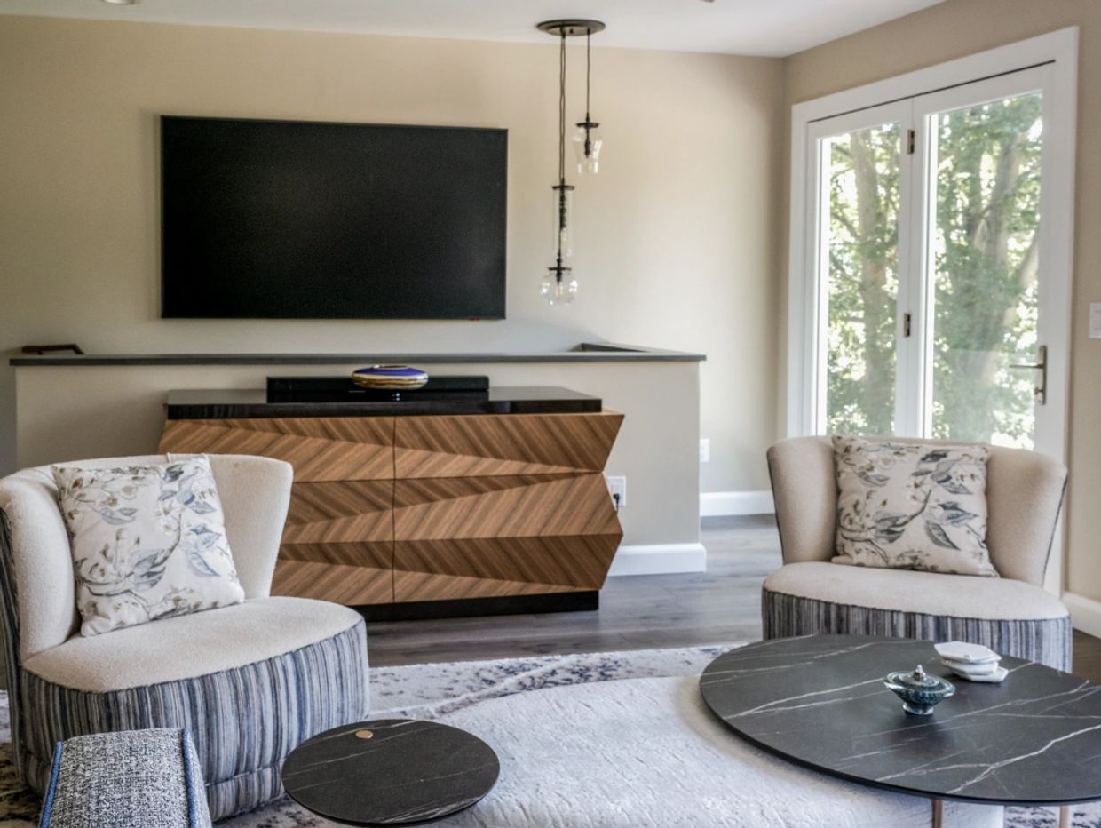 Modern living room with unique wooden cabinet and cozy chairs.