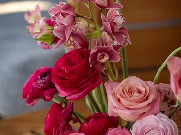 A vibrant bouquet of pink and red flowers with delicate petals.