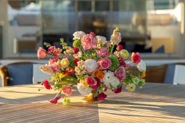 Colorful flower arrangement in a vase on a wooden table.
