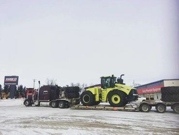 A truck carrying a tractor