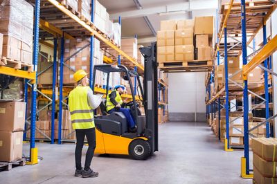 Safety trainer teaching a forklift safety class to a construction worker