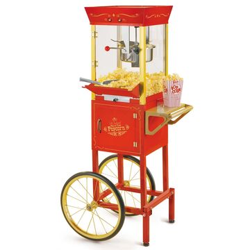 Vintage-style red popcorn machine with large wheels and popcorn inside.