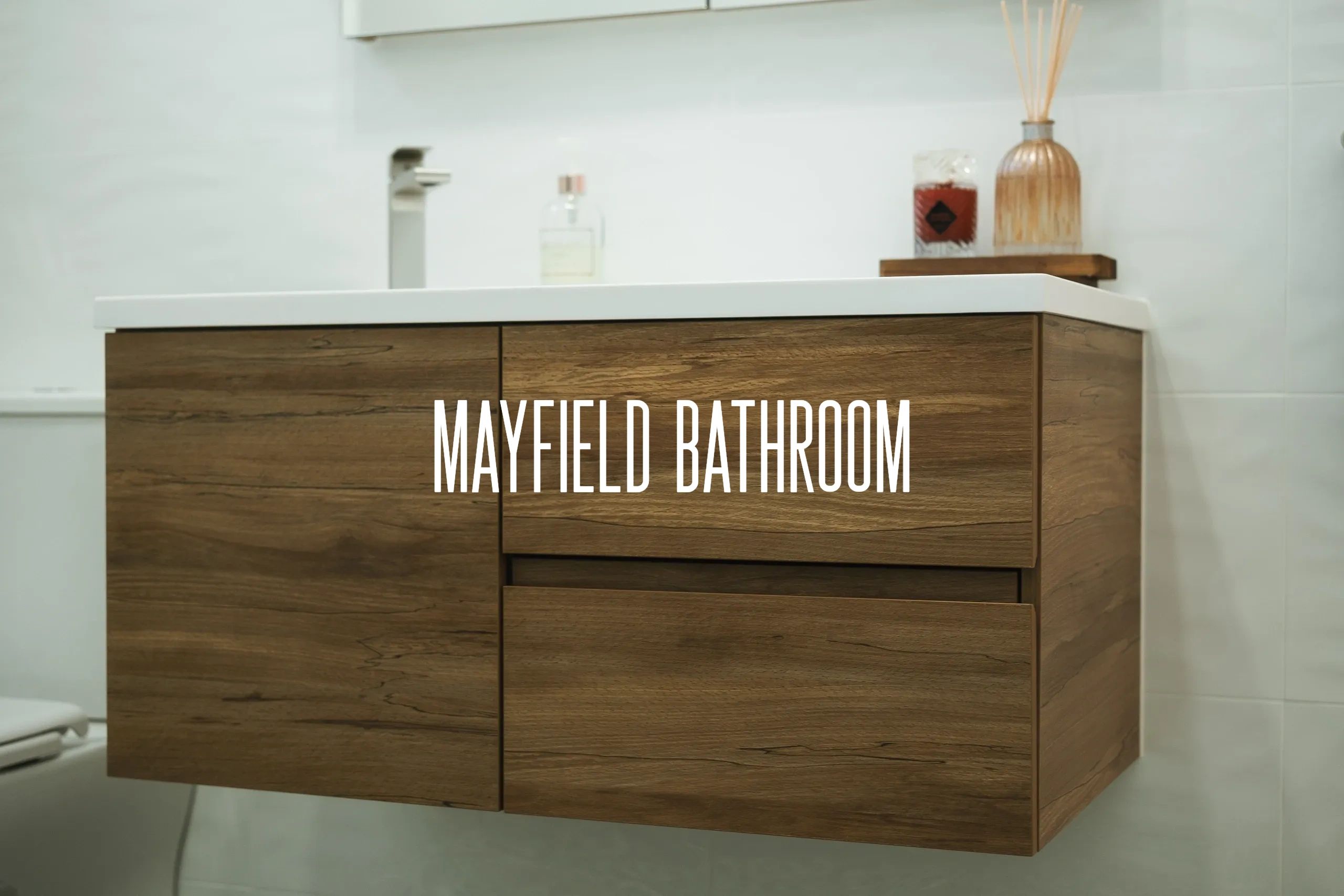 Modern wooden bathroom vanity with white countertop and decorative items.

Ensuite renovation, bathroom remodeling, home improvement. The complete process