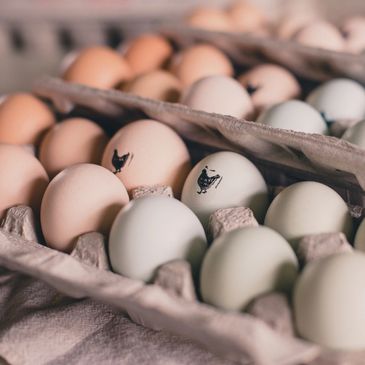 Cartons of farm fresh eggs with a hen stamp.