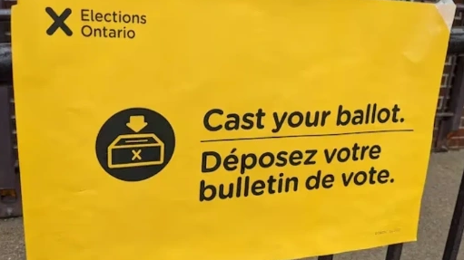 Sign instructing to cast your ballot in English and French.