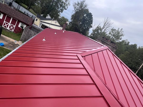 A red rooftop with tress surrounded