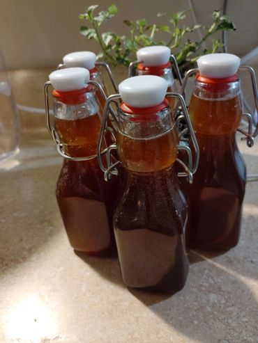 Simple Syrup from Simply Elderberry Product with flowers in background 