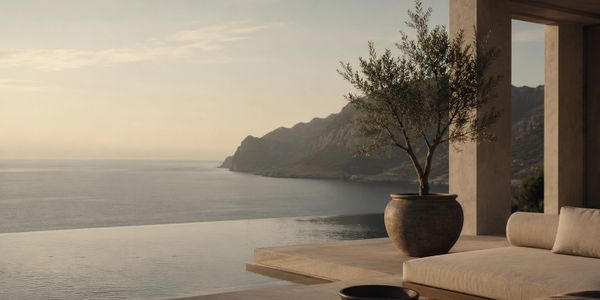 Minimal Mediterranean luxury setting overlooking the Aegean Sea at golden hour