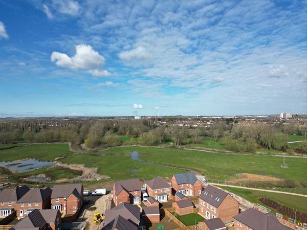 Drone image of new build houses, homes and surrounding fields