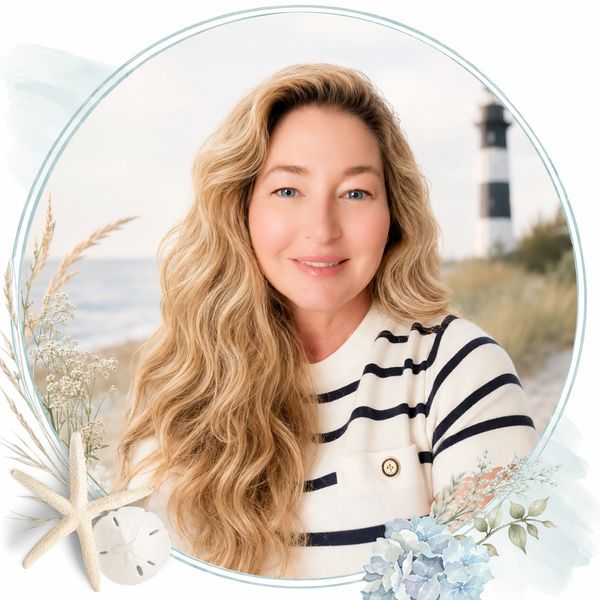 Smiling woman with long curly hair by the beach lighthouse.