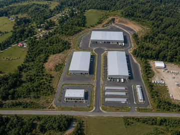 Aerial view of a modern industrial complex surrounded by greenery.