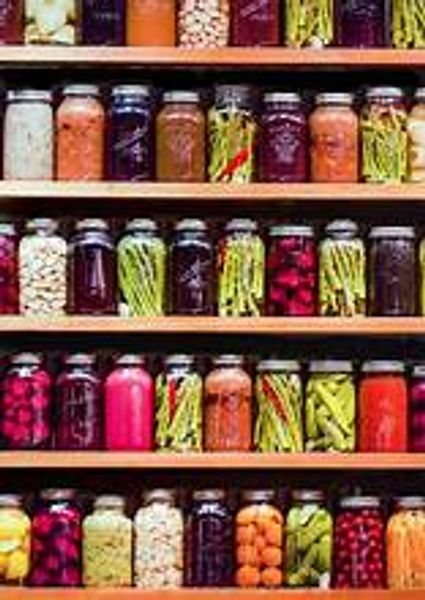 Shelves filled with colorful jars of pickled vegetables and preserves.