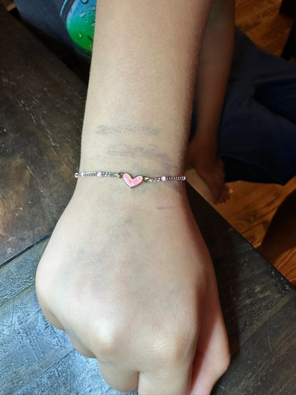 pink heart bracelet.