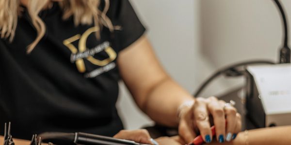 Woman getting a manicure at a nail salon.