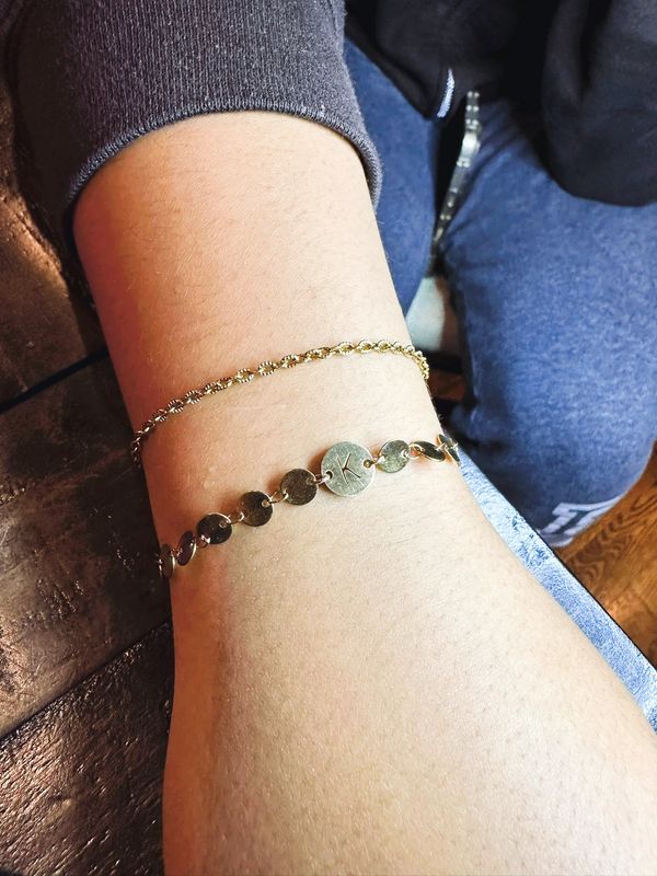 Close-up of a wrist with gold bracelets.