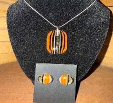 Orange and black striped pendant necklace with matching earrings.