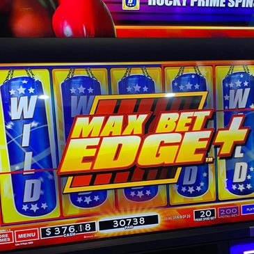 Slot machine showing a big win with 'Max Bet Edge+' on screen.