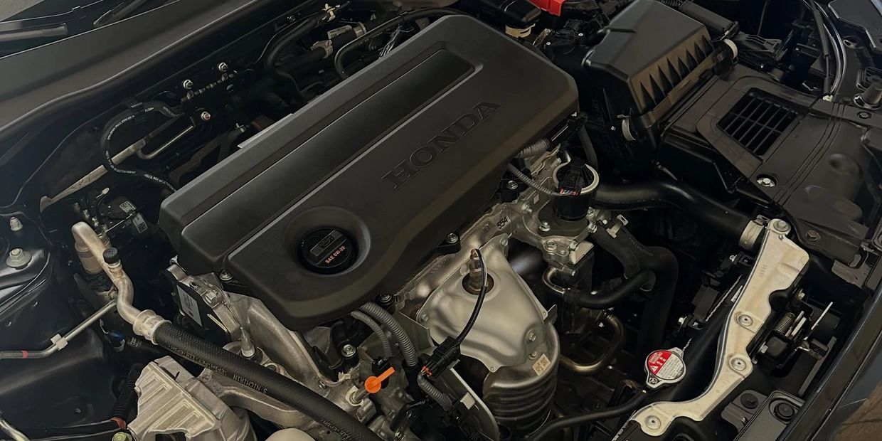 Close-up of a Honda car engine under the hood.