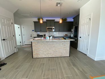 Modern kitchen with a central island and pendant lights.