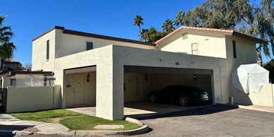 Modern two-story house with a garage and a car parked inside.