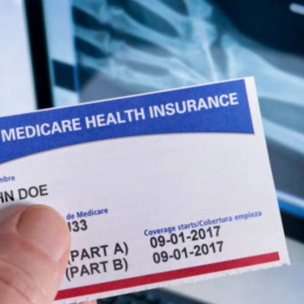 Medicare health insurance card held by a person.