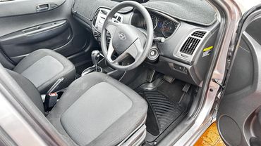 Interior of a Hyundai car showing the driver's seat and dashboard.