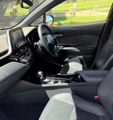 Interior view of a modern car with a touchscreen and leather seats.