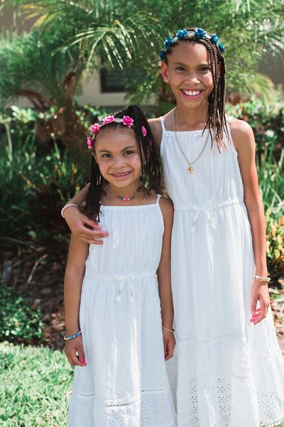 Black girls in white dresses with flower headbands sisters siblings