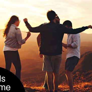 Four friends enjoying a sunset hike together.