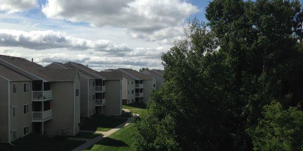 High angle view of back-to-back apartment buildings with trees.