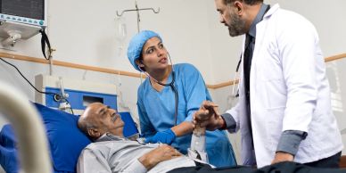Doctors attending to an elderly patient in a hospital.