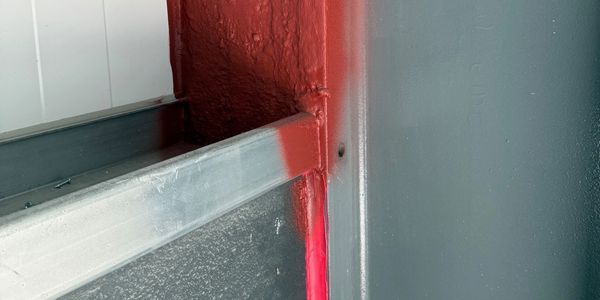 Compatible STI products used to firestop the gap between structural steel frame & Inslt Metal Panels