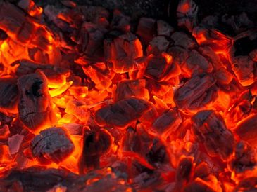 Glowing hot embers glowing with intense orange and red hues.