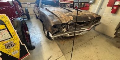 Rusty vintage car in a garage.