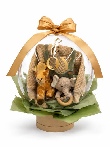 Gift set with baby outfit and plush toys wrapped in clear balloon and gold ribbon.