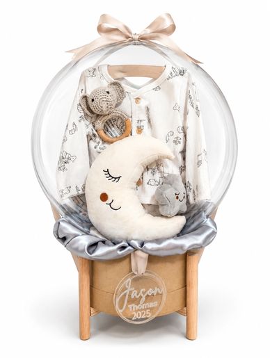 Baby gift set with moon pillow and stuffed animals in a clear balloon.
