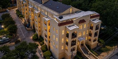 A well-lit residential building at dusk.