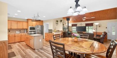 Bright kitchen and dining area with wooden furniture.