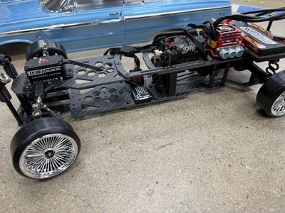 Chassis of a remote control car with detailed wheels and engine.