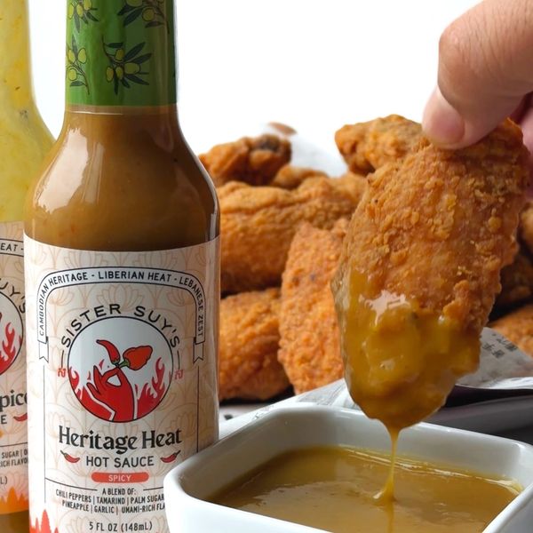 Fried chicken wings with Sister Suy's Mellow Spice hot sauce