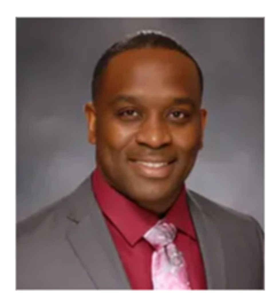 Professional man smiling in a suit and tie.