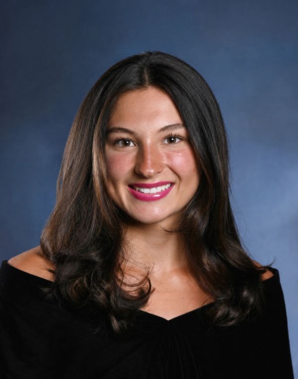 Portrait of a smiling young woman with dark hair.