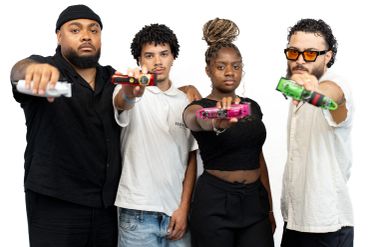 Four diverse young adults holding vape devices towards the camera.