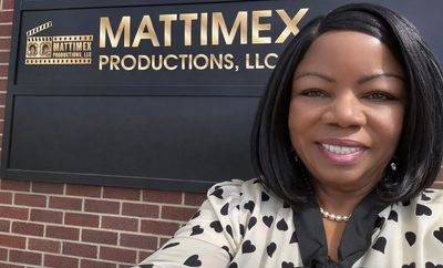 Woman smiling outside Mattimex Productions, LLC building.
