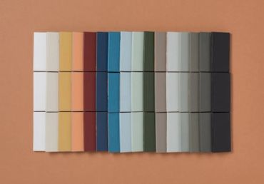 A palette of rectangular color tiles arranged in rows on a brown surface.